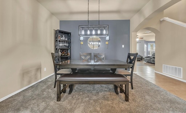 dining space with tile patterned floors and ceiling fan