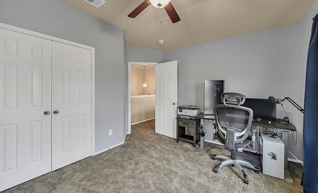 carpeted office space with ceiling fan