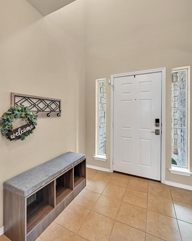 entrance foyer with light tile patterned floors and a healthy amount of sunlight