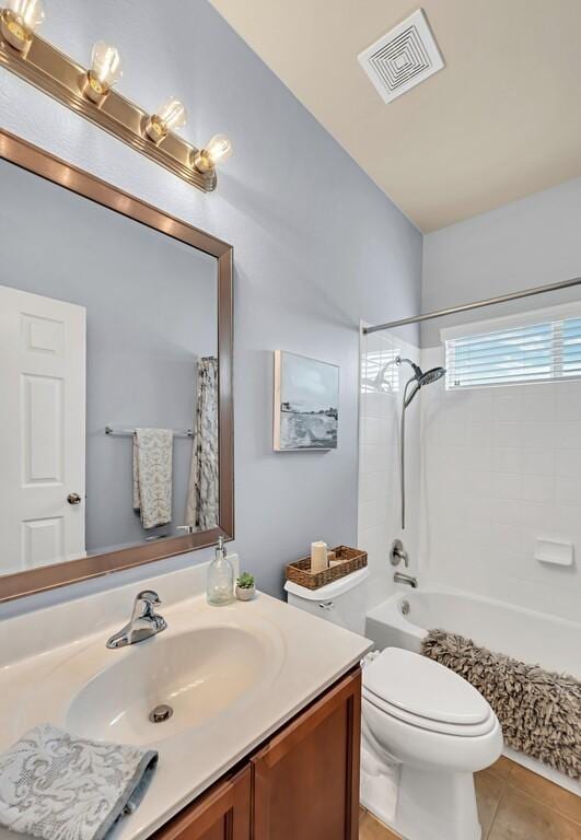 full bathroom with tile patterned flooring, vanity, toilet, and shower / bath combo with shower curtain