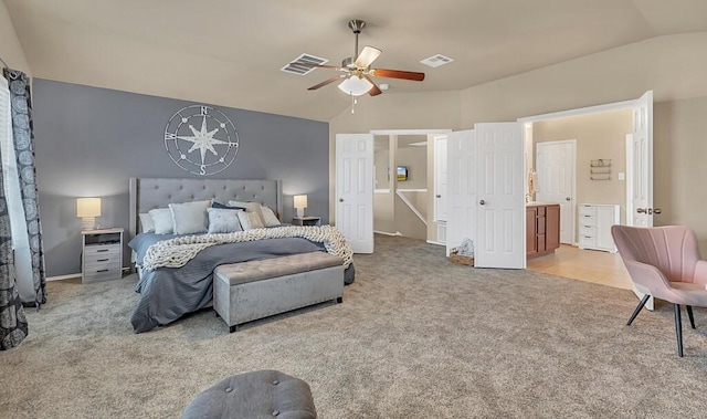 carpeted bedroom with connected bathroom, ceiling fan, and lofted ceiling