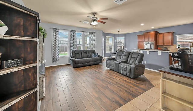 living room featuring light wood-type flooring and ceiling fan