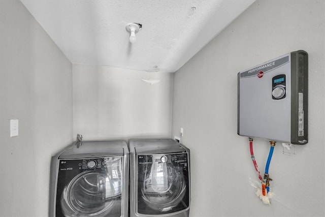 washroom featuring washer and dryer, a textured ceiling, and water heater