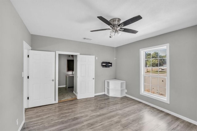 unfurnished bedroom featuring ceiling fan and light hardwood / wood-style floors