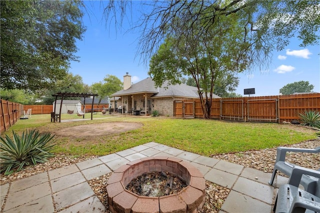 view of yard with a fire pit, a pergola, and a patio