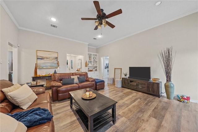 living room featuring crown molding, ceiling fan, and light wood-type flooring