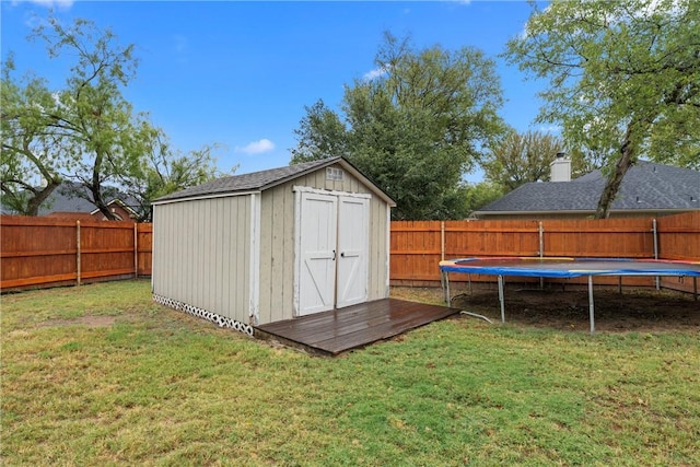 view of outdoor structure featuring a trampoline and a lawn