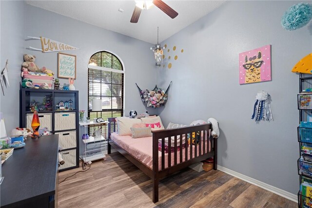 bedroom with ceiling fan and hardwood / wood-style flooring