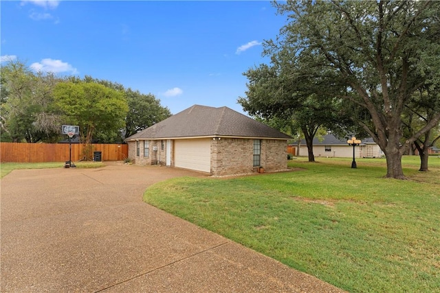 view of side of home with a lawn and a garage