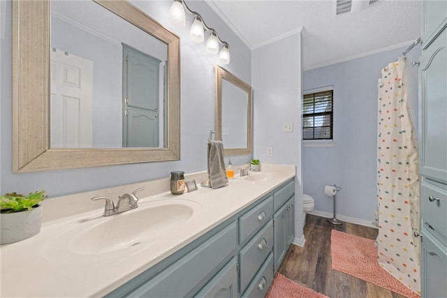 bathroom with a shower with curtain, hardwood / wood-style floors, toilet, vanity, and ornamental molding