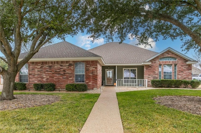 ranch-style house with covered porch and a front lawn