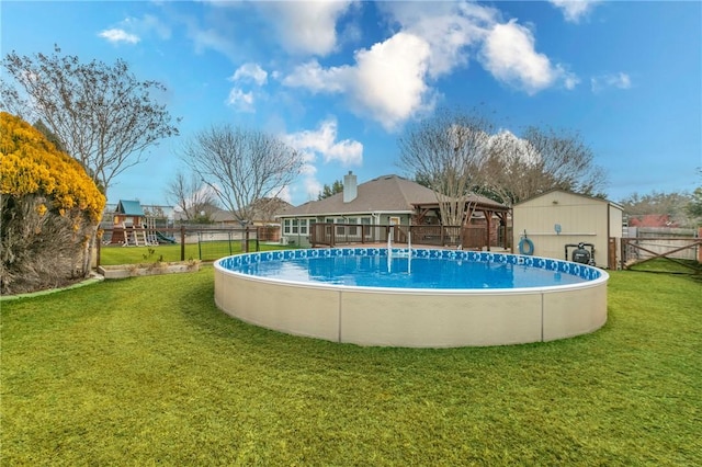 view of pool with a playground and a lawn