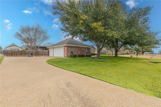 ranch-style house featuring a garage and a front yard