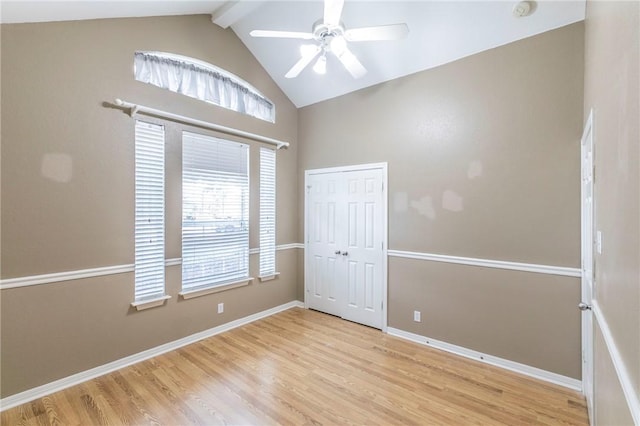 spare room featuring lofted ceiling, ceiling fan, and light hardwood / wood-style flooring