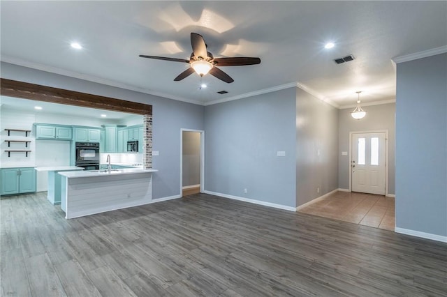 kitchen with pendant lighting, hardwood / wood-style floors, and kitchen peninsula