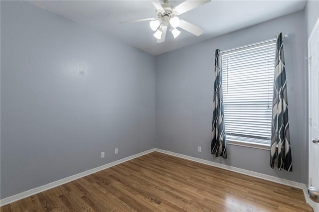 spare room with wood-type flooring and ceiling fan