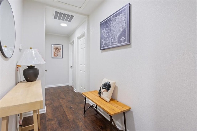 hall featuring crown molding and dark hardwood / wood-style flooring