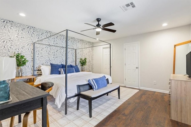 bedroom with ceiling fan and hardwood / wood-style flooring