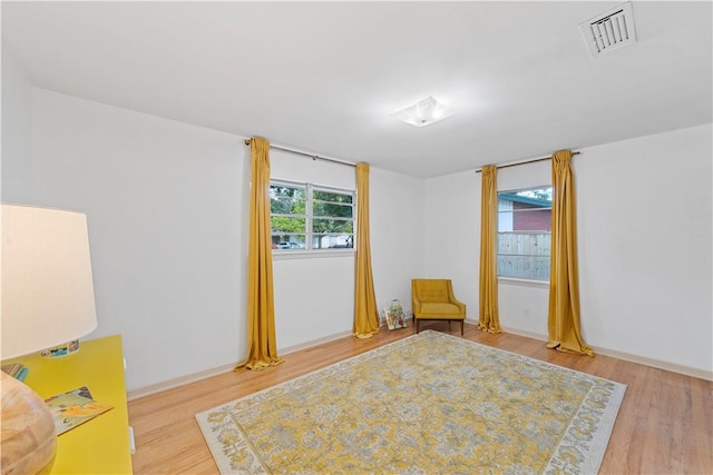 unfurnished room with light wood-type flooring