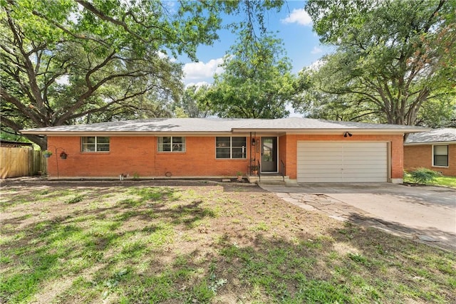 ranch-style house featuring a garage and a front lawn