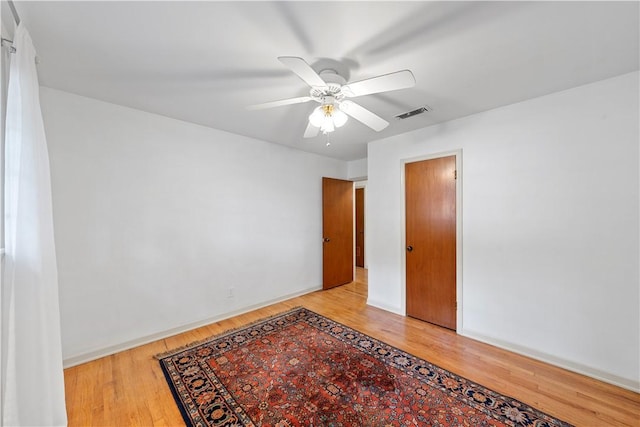 empty room featuring ceiling fan and light hardwood / wood-style floors