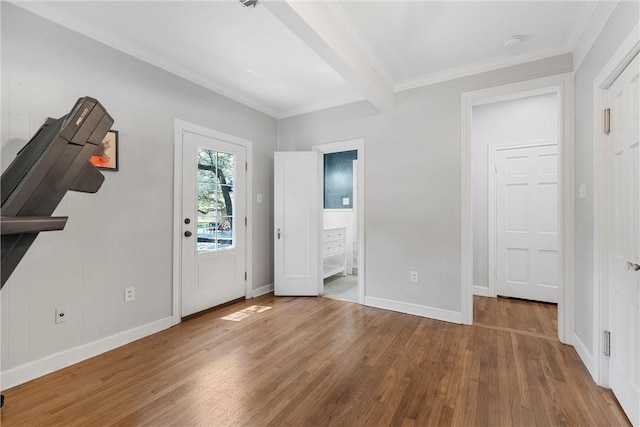 entrance foyer with hardwood / wood-style floors, crown molding, and beam ceiling