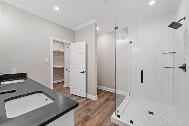 bathroom featuring wood-type flooring, toilet, an enclosed shower, and ornamental molding