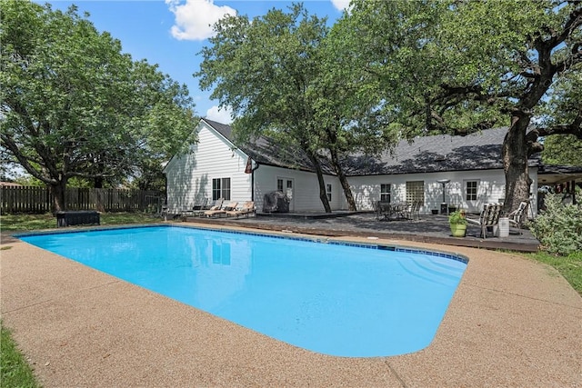 view of swimming pool featuring a patio area