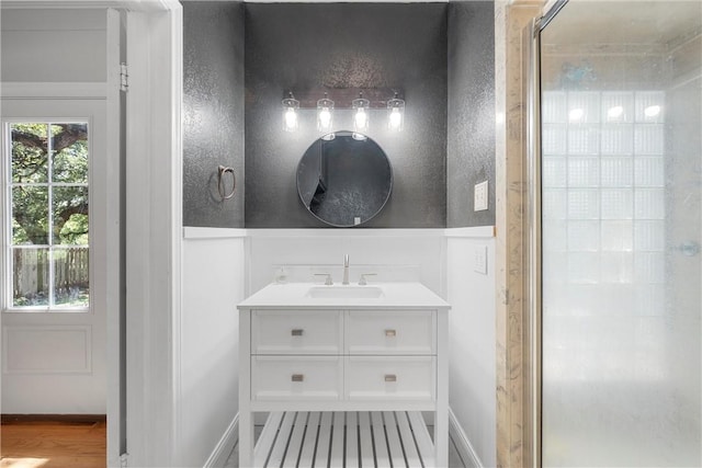 bathroom featuring vanity, an enclosed shower, and hardwood / wood-style flooring