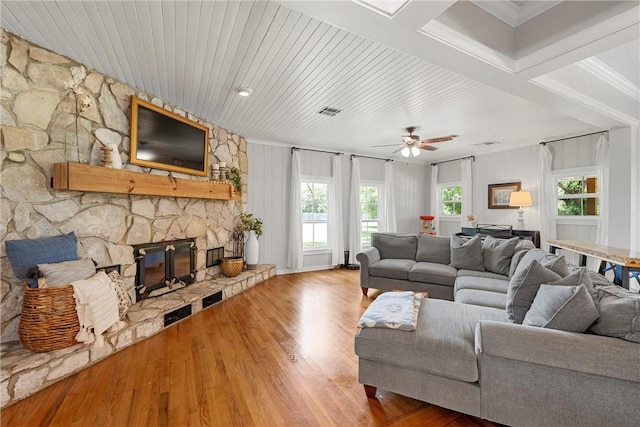 living room with a fireplace, hardwood / wood-style floors, a wealth of natural light, and ceiling fan