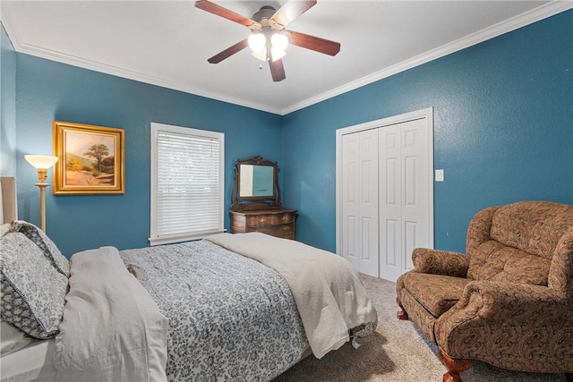 bedroom with carpet flooring, a closet, ceiling fan, and crown molding