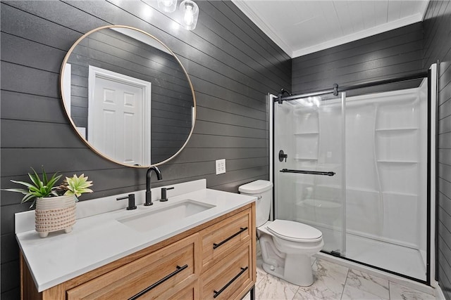 bathroom featuring ornamental molding, vanity, a shower with door, toilet, and wood walls