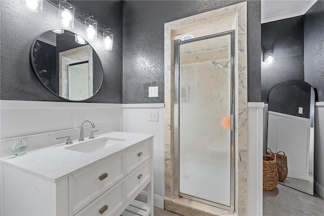 bathroom featuring tile patterned floors, crown molding, vanity, and a shower with shower door