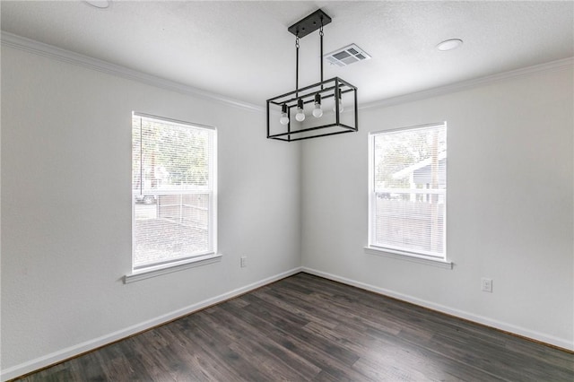 unfurnished dining area with ornamental molding, dark hardwood / wood-style flooring, and a healthy amount of sunlight