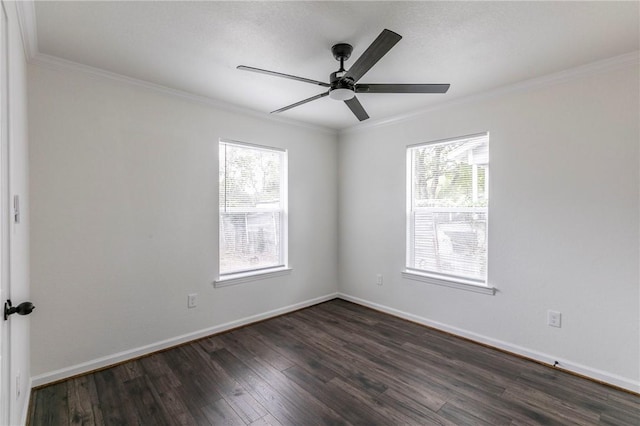 spare room featuring dark hardwood / wood-style flooring, a wealth of natural light, crown molding, and ceiling fan