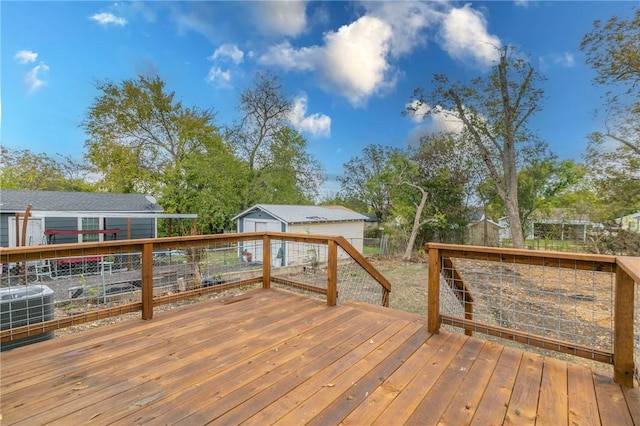 wooden terrace featuring cooling unit and an outdoor structure