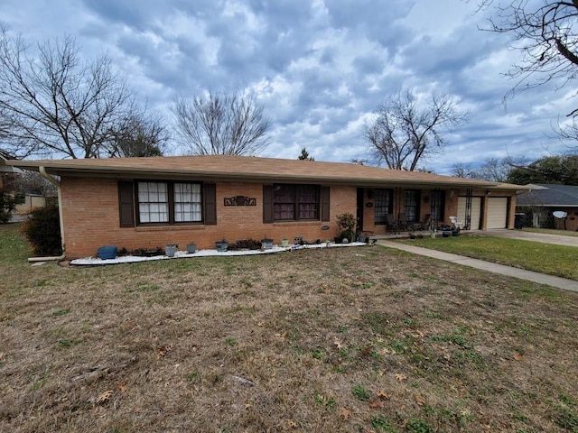 ranch-style house featuring a garage and a front yard