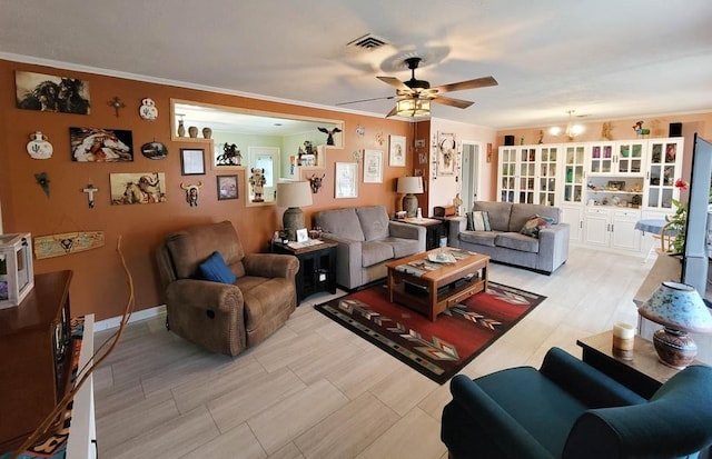 living room with ceiling fan with notable chandelier