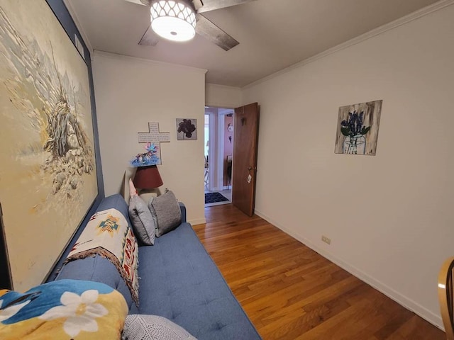 interior space featuring ceiling fan, ornamental molding, and hardwood / wood-style floors