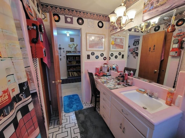 bathroom with a chandelier and vanity