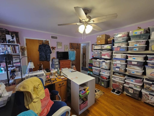 office featuring light wood-type flooring, ceiling fan, and ornamental molding