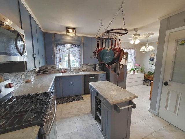 kitchen featuring decorative backsplash, a wealth of natural light, sink, stainless steel appliances, and ceiling fan with notable chandelier