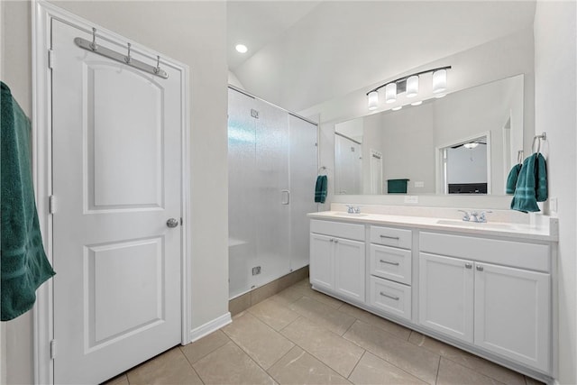 bathroom with tile patterned floors, a shower with door, vanity, and lofted ceiling