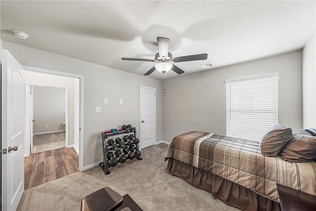 carpeted bedroom with a textured ceiling and ceiling fan