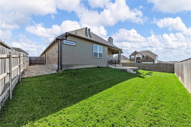 back of house featuring a yard and a patio