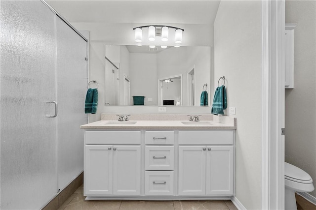 bathroom featuring tile patterned flooring, vanity, an enclosed shower, and toilet