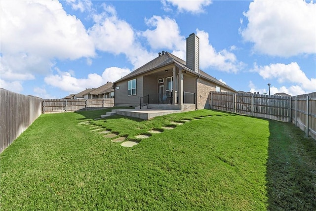 rear view of house featuring a lawn and a patio area