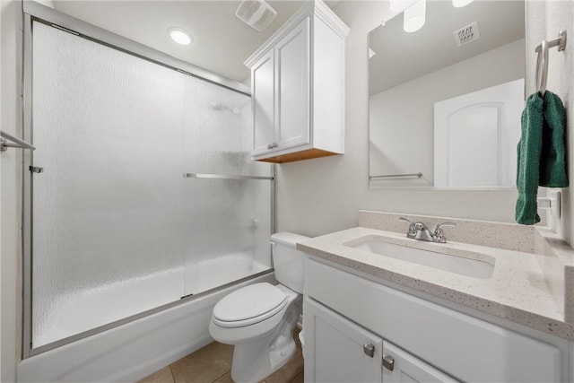 full bathroom featuring tile patterned floors, vanity, toilet, and bath / shower combo with glass door