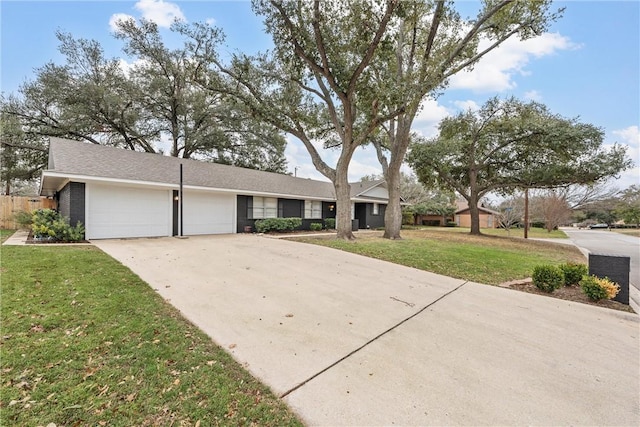 ranch-style home with a garage, driveway, and a front yard