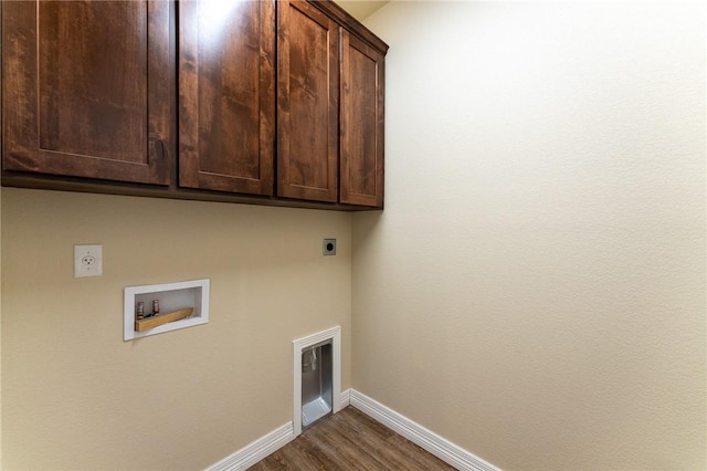 laundry room with hookup for an electric dryer, cabinets, wood-type flooring, and hookup for a washing machine